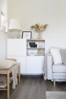 White square storage cabinet in the corner of a modern living room