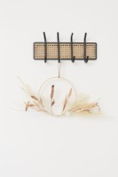 Metal and rattan coat hooks with a hanging dried flower wreath