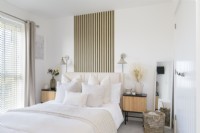Modern bedroom with slatted wood effect wallpaper