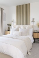 Modern bedroom with slatted wood effect wallpaper
