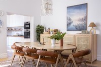 Dining room with modern sideborad, table and leather chairs