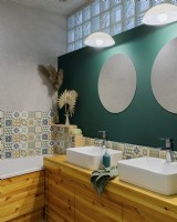 Bathroom with green wall and double sinks