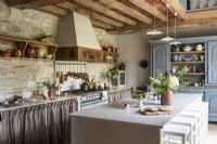 Modern white island in rustic country kitchen