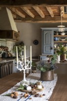 Rustic dining room table with central runner in country kitchen-diner