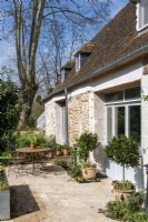 Country home exterior with bistro table on terrace