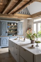 White island in country kitchen with exposed beams