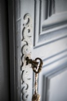 Detail of old door with original metal key in keyhole