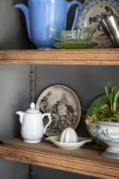 Detail of vintage plates and crockery on shelves