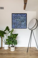Modern artwork, floor lamp and houseplants