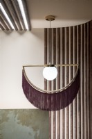 Detail of modern light fitting with fabric tassels 