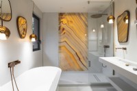 Golden yellow marbled glass panel in contemporary shower cubicle 