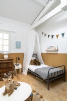 Childrens bedroom with split painted wall