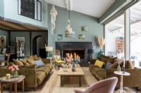Eclectic living room with lit fireplace at one end