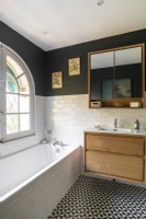 Monochrome bathroom with wooden cabinets 