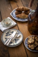 Coffee cup and cakes on dining room table - detail
