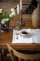 Coffee cup on country dining table - detail
