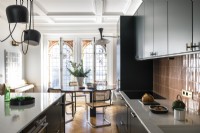 Modern kitchen-diner with stained glass windows at one end