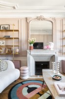 Modern furniture in pink painted living room with period features