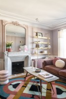 Modern pink themed living room with period features