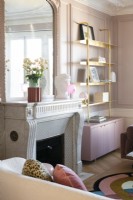 Pink painted walls and original features in modern living room