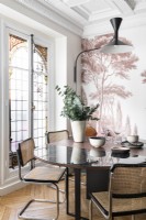 Tree mural on feature wall behind modern dining table