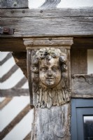 Carved wooden face on exterior of 16th Century manor house - detail
