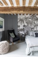 Grey bedroom with tropical scene feature wall