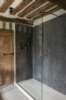Grey mosaic tiling in modern shower cubicle