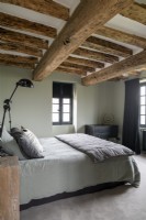 Modern country bedroom with pale green walls and grey furnishings