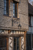 Exterior of 16th Century manor house with classic lamp