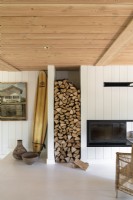 Firewood storage in alcove next to wood burning stove in cabin