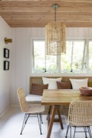 Modern white and wooden dining room in cabin style cottage