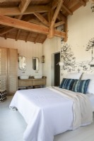 White country bedroom with mural feature wall