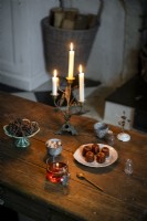 Cakes and candles on rustic wooden dining table