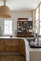 Country kitchen with wooden cupboards and shelving unit