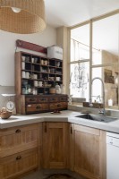 Reclaimed wooden shelving unit on country kitchen worktop
