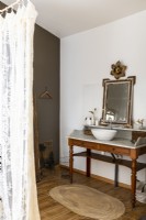 Antique vanity unit and sink in country bathroom