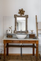 Vintage vanity unit with sink in country bathroom