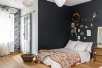 Country bedroom with black painted wall and cloud wallpaper