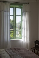 View of open windows and thin linen curtains