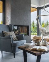 Armchair and coffee table with decorations on the background of the fireplace