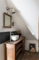Wooden unit with small sink in country bathroom