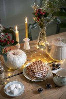 Waffles on a plate next to a pumpkin - dining table detail