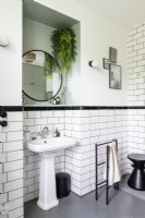 Sink in recess in modern black and white bathroom