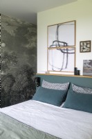 Mural and framed artwork in modern grey and white bedroom