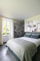 Decorative feature wall in modern grey and white bedroom