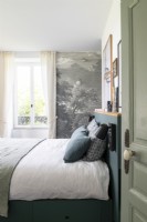 Modern grey and white bedroom with painting on feature wall