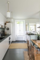 Modern kitchen with white painted walls and grey concrete floor