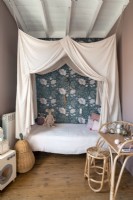 Childrens bed with canopy and floral wallpaper feature wall