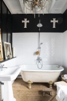 Large crosses on black wall in country bathroom